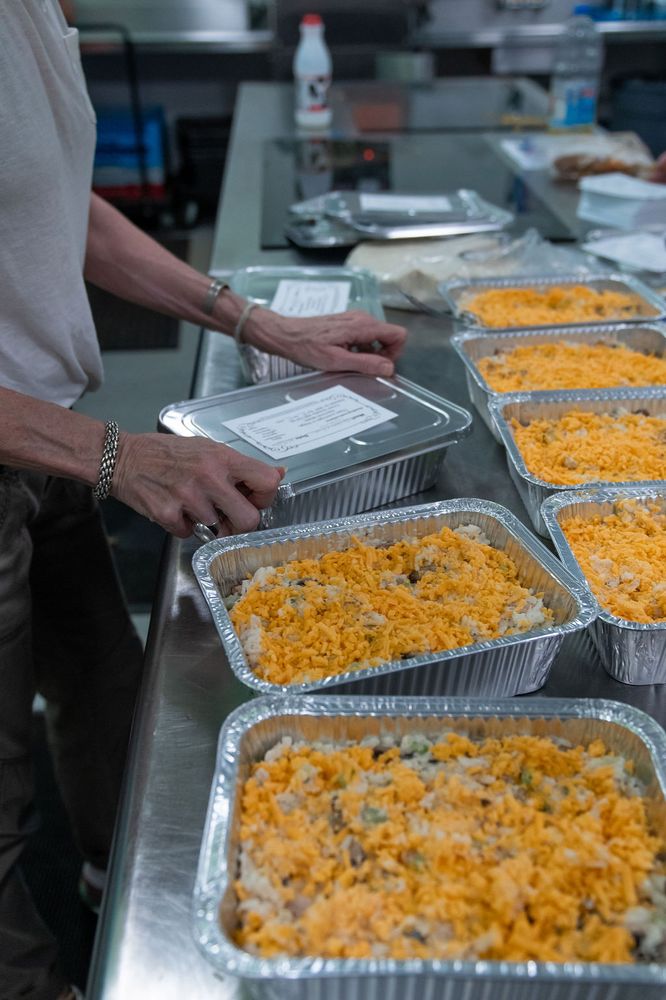 A long row of foil trays filled and ready for the freezer