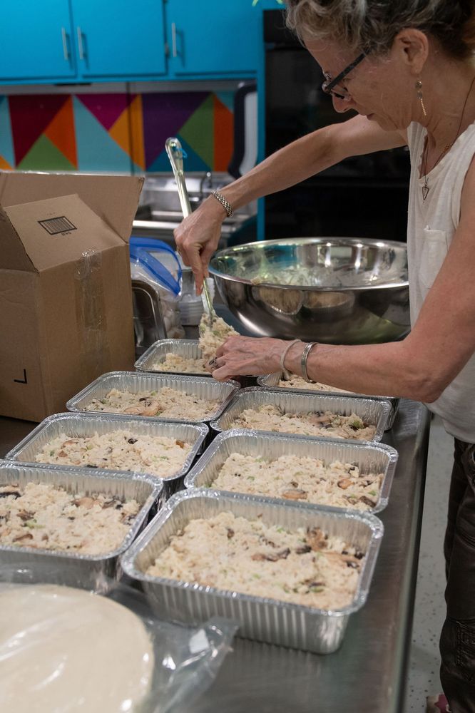 Meals being packed and labeled into freezer bags