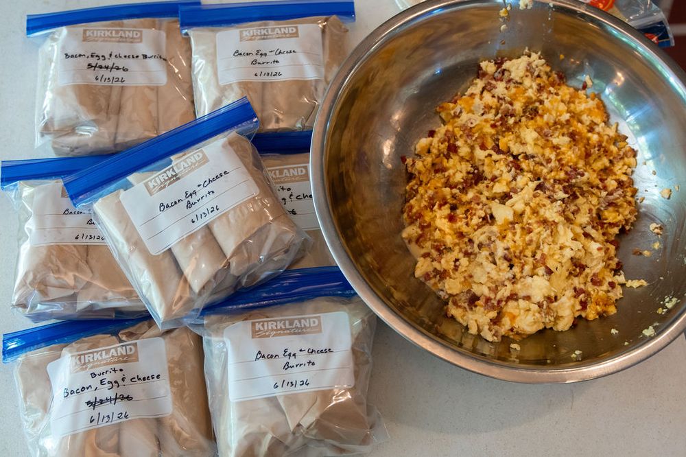 A big bowl of filling beside bagged meals ready to freeze