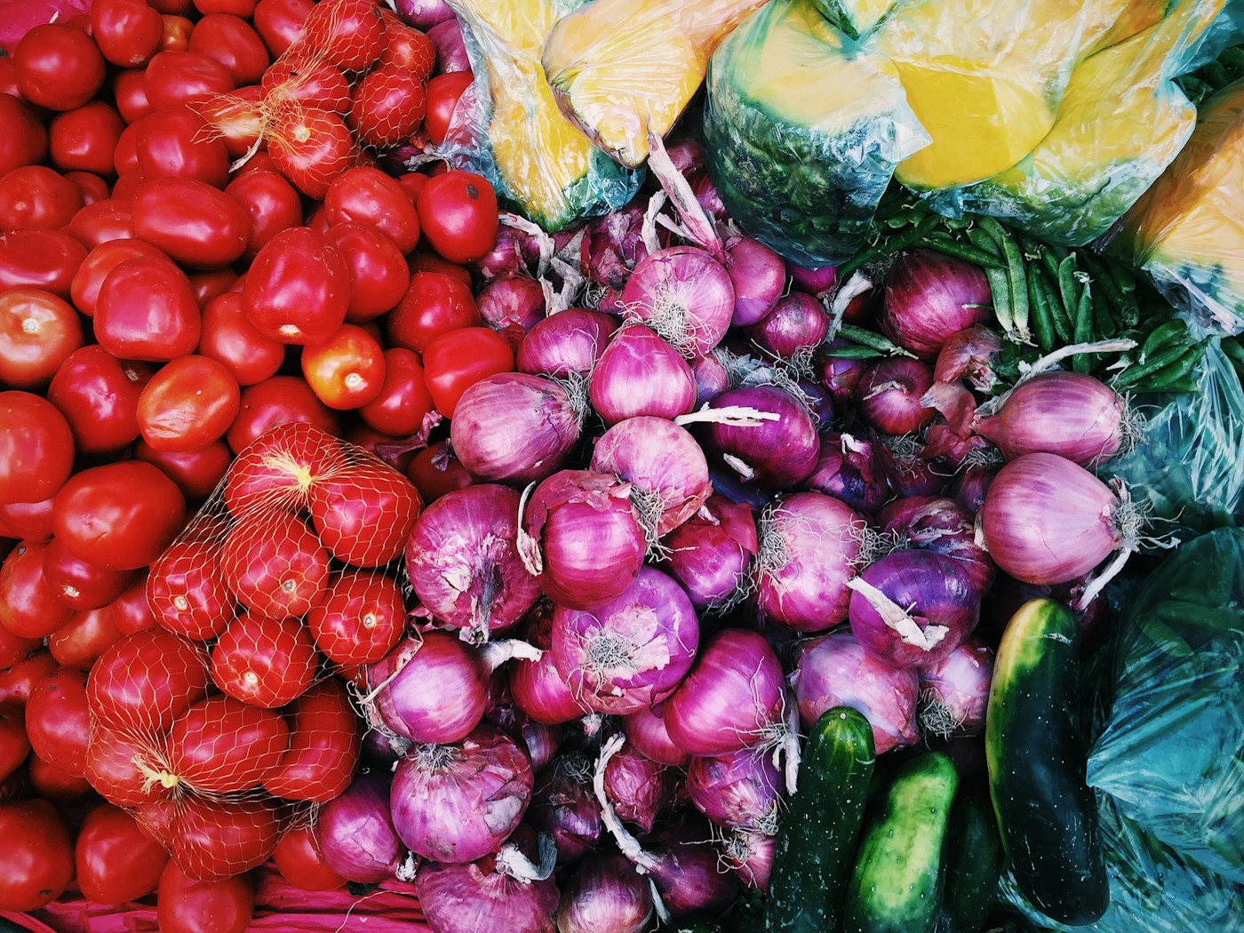 A colorful spread of fresh tomatoes, onions and produce contributed for a cook day